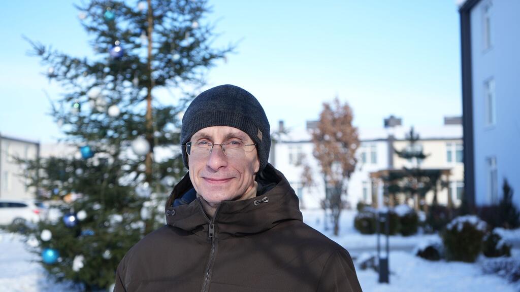 Yurii Shapovalov stands outside a dormitory for displaced people in a suburb of Kyiv, where he is rebuilding his life after years in captivity.